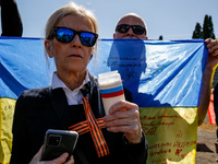 Pro-Ukrain and pro-Russian activists wait for Sergey Andreyev, Russian Ambassador to Poland to arrive to lay flowers at the Mausoleum of the...