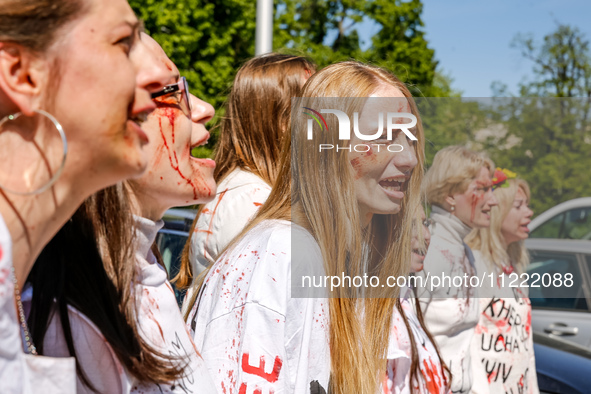 Pro-Ukraine activists shaut and cry as Sergey Andreyev, Russian Ambassador to Poland arrive to lay flowers at the Mausoleum of the Soviet So...