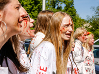 Pro-Ukraine activists shaut and cry as Sergey Andreyev, Russian Ambassador to Poland arrive to lay flowers at the Mausoleum of the Soviet So...