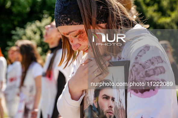 Pro-Ukraine activists shaut and cry as Sergey Andreyev, Russian Ambassador to Poland arrive to lay flowers at the Mausoleum of the Soviet So...