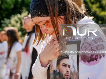 Pro-Ukraine activists shaut and cry as Sergey Andreyev, Russian Ambassador to Poland arrive to lay flowers at the Mausoleum of the Soviet So...