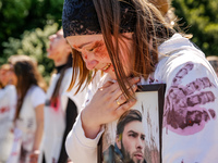 Pro-Ukraine activists shaut and cry as Sergey Andreyev, Russian Ambassador to Poland arrive to lay flowers at the Mausoleum of the Soviet So...