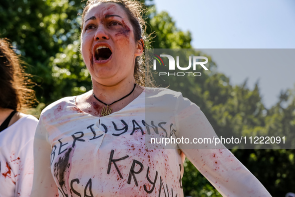 Pro-Ukraine activists shaut and cry as Sergey Andreyev, Russian Ambassador to Poland arrive to lay flowers at the Mausoleum of the Soviet So...