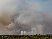 Smoke is rising behind the hill in Limassol, Cyprus, on May 9, 2024. A wildfire has broken out at the Industrial Zone of Ipsonas, a few kilo...