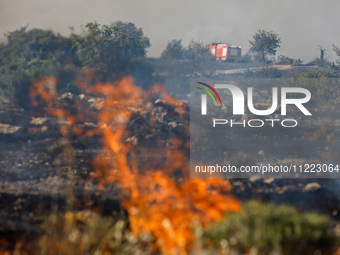 A fire truck is seen in the distance in Limassol, Cyprus, on May 9, 2024. A wildfire is breaking out at the Industrial Zone of Ipsonas, a fe...