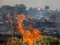 A fire truck is seen in the distance in Limassol, Cyprus, on May 9, 2024. A wildfire is breaking out at the Industrial Zone of Ipsonas, a fe...