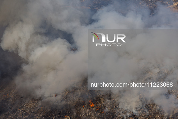 Thick smoke and fire are engulfing the area in Limassol, Cyprus, on May 9, 2024. A wildfire is raging in the Industrial Zone of Ipsonas, a f...