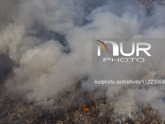 Thick smoke and fire are engulfing the area in Limassol, Cyprus, on May 9, 2024. A wildfire is raging in the Industrial Zone of Ipsonas, a f...