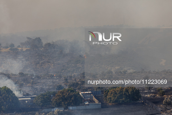 A fire is burning next to an industrial site in Limassol, Cyprus, on May 9, 2024. The wildfire, which broke out in the Industrial Zone of Ip...