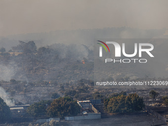 A fire is burning next to an industrial site in Limassol, Cyprus, on May 9, 2024. The wildfire, which broke out in the Industrial Zone of Ip...