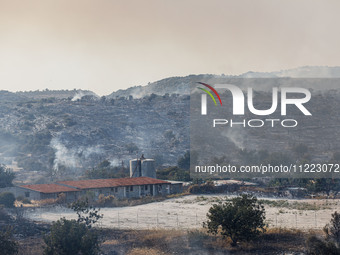 A fire is burning next to an industrial site in Limassol, Cyprus, on May 9, 2024. The wildfire, which broke out in the Industrial Zone of Ip...