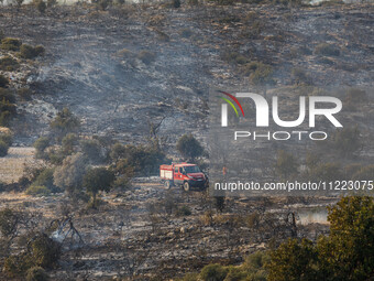 A fire truck is on site in Limassol, Cyprus, on May 9, 2024. A wildfire is burning at the Industrial Zone of Ipsonas, a few kilometers away...