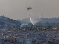 A helicopter is operating during a fire in Limassol, Cyprus, on May 9, 2024. The wildfire, which broke out in the Industrial Zone of Ipsonas...