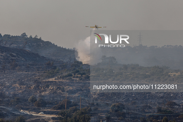 An airplane is operating during a fire in Limassol, Cyprus, on May 9, 2024. The wildfire, which broke out in the Industrial Zone of Ipsonas...