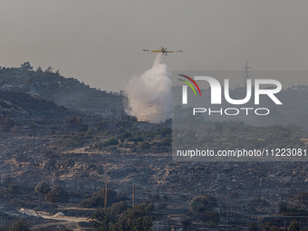 An airplane is operating during a fire in Limassol, Cyprus, on May 9, 2024. The wildfire, which broke out in the Industrial Zone of Ipsonas...