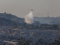 An airplane is operating during a fire in Limassol, Cyprus, on May 9, 2024. The wildfire, which broke out in the Industrial Zone of Ipsonas...