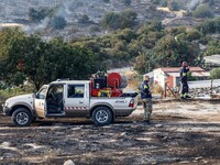 Volunteers are assisting during a wildfire in Limassol, Cyprus, on May 9, 2024. The fire, which started in the Industrial Zone of Ipsonas, a...