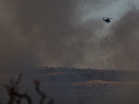 A helicopter is operating during a fire in Limassol, Cyprus, on May 9, 2024. The wildfire, which broke out in the Industrial Zone of Ipsonas...