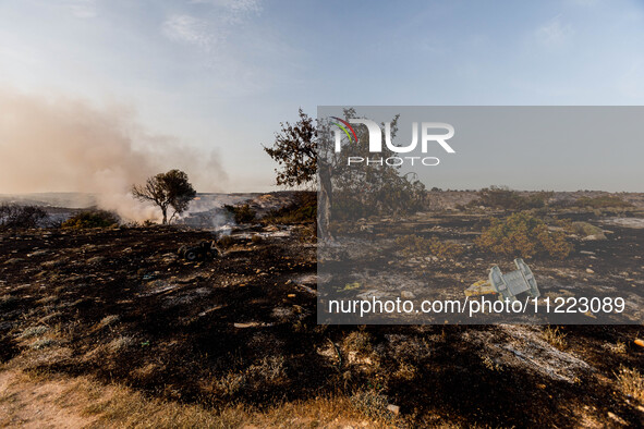 Burnt toys are being seen on site in Limassol, Cyprus, on May 9, 2024. A wildfire is breaking out at the Industrial Zone of Ipsonas, a few k...