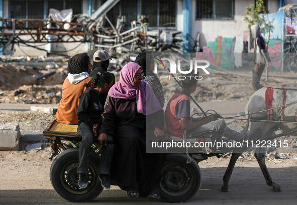 Displaced Palestinians are returning to Khan Yunis in the southern Gaza Strip to set up shelter amid the ongoing conflict between Israel and...