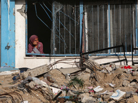 A displaced Palestinian woman is looking out of a school window after returning to Khan Yunis in the southern Gaza Strip, on May 9, 2024, am...