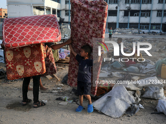 Displaced Palestinians are returning to Khan Yunis in the southern Gaza Strip to set up shelter amid the ongoing conflict between Israel and...