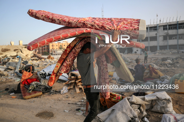 Displaced Palestinians are returning to Khan Yunis in the southern Gaza Strip to set up shelter amid the ongoing conflict between Israel and...