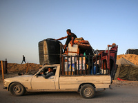 Displaced Palestinians are arriving in a truck carrying their belongings to set up shelter after returning to Khan Yunis in the southern Gaz...