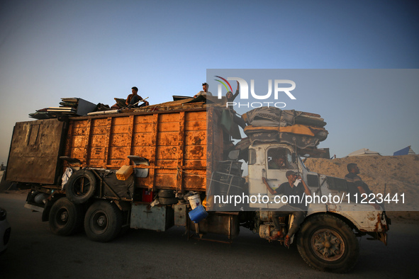 Displaced Palestinians are arriving in a truck carrying their belongings to set up shelter after returning to Khan Yunis in the southern Gaz...