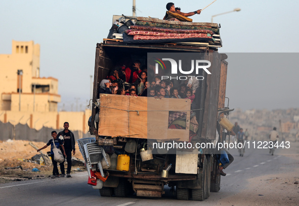 Displaced Palestinians are arriving in a truck carrying their belongings to set up shelter after returning to Khan Yunis in the southern Gaz...