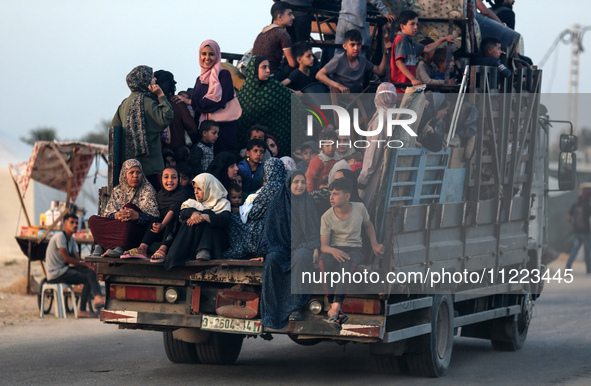 Displaced Palestinians are arriving in a truck carrying their belongings to set up shelter after returning to Khan Yunis in the southern Gaz...