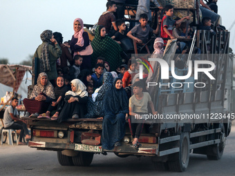 Displaced Palestinians are arriving in a truck carrying their belongings to set up shelter after returning to Khan Yunis in the southern Gaz...