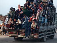 Displaced Palestinians are arriving in a truck carrying their belongings to set up shelter after returning to Khan Yunis in the southern Gaz...