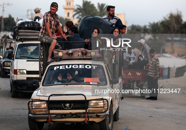 Displaced Palestinians are arriving in a truck carrying their belongings to set up shelter after returning to Khan Yunis in the southern Gaz...