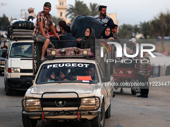 Displaced Palestinians are arriving in a truck carrying their belongings to set up shelter after returning to Khan Yunis in the southern Gaz...