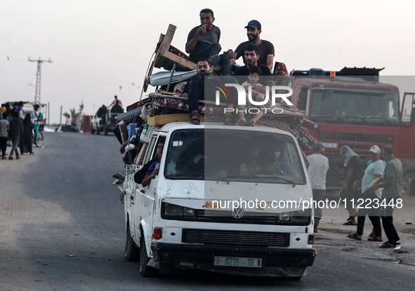 Displaced Palestinians are arriving in a truck carrying their belongings to set up shelter after returning to Khan Yunis in the southern Gaz...