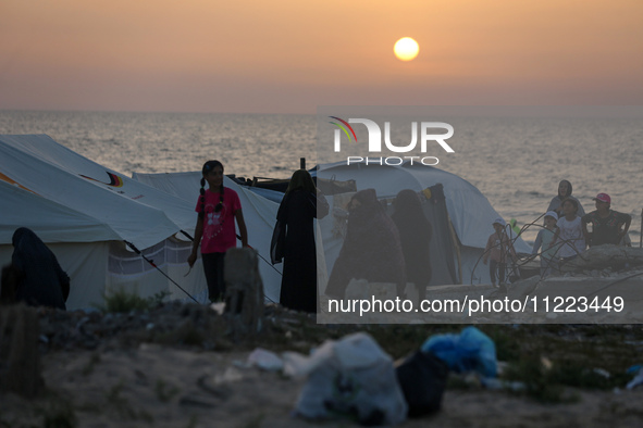 Displaced Palestinians are setting up tents on a beach near Khan Yunis in the southern Gaza Strip, amid the ongoing conflict between Israel...