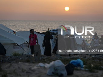 Displaced Palestinians are setting up tents on a beach near Khan Yunis in the southern Gaza Strip, amid the ongoing conflict between Israel...