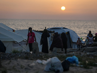 Displaced Palestinians are setting up tents on a beach near Khan Yunis in the southern Gaza Strip, amid the ongoing conflict between Israel...