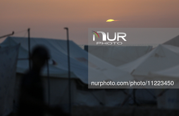 Displaced Palestinians are setting up tents on a beach near Khan Yunis in the southern Gaza Strip, amid the ongoing conflict between Israel...