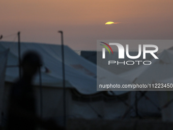 Displaced Palestinians are setting up tents on a beach near Khan Yunis in the southern Gaza Strip, amid the ongoing conflict between Israel...