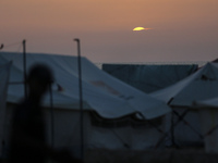 Displaced Palestinians are setting up tents on a beach near Khan Yunis in the southern Gaza Strip, amid the ongoing conflict between Israel...