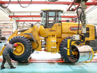 Workers are producing loaders on a production line at LOVOL Co in Qingdao, Shandong Province, China, on May 9, 2024. (