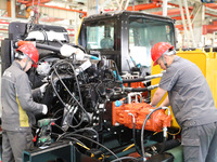 Workers are producing loaders on a production line at LOVOL Co in Qingdao, Shandong Province, China, on May 9, 2024. (