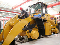 Workers are producing loaders on a production line at LOVOL Co in Qingdao, Shandong Province, China, on May 9, 2024. (