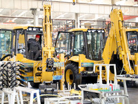 Workers are debugging an excavator on the production line of LOVOL Co in Qingdao, Shandong Province, China, on May 9, 2024. (