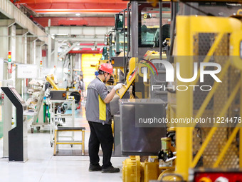 Workers are working on the production line at LOVOL Co in Qingdao, Shandong Province, China, on May 9, 2024. (