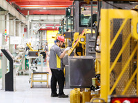 Workers are working on the production line at LOVOL Co in Qingdao, Shandong Province, China, on May 9, 2024. (