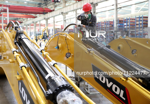 Workers are working on the production line at LOVOL Co in Qingdao, Shandong Province, China, on May 9, 2024. 