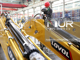 Workers are working on the production line at LOVOL Co in Qingdao, Shandong Province, China, on May 9, 2024. (